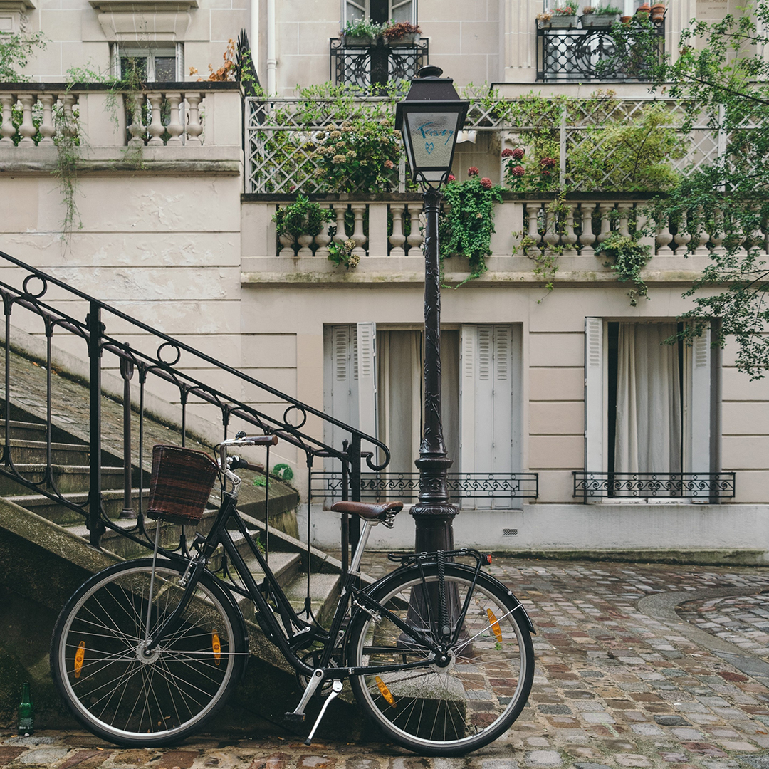 Contact - Contact us. Vintage bicycle parked on a quaint Parisian street, symbolizing the local charm infused into Bonjour Australia's French lessons in Linden Park, Adelaide.