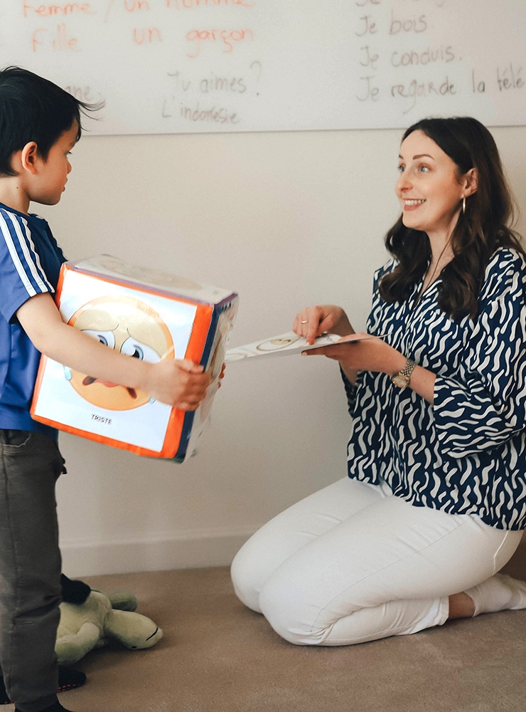 French School - Adelaide, Young boy learning French with a teacher at a French school in Adelaide, Australia, with classroom whiteboard in the background displaying basic French sentences, private french lessons near me, where to learn french near me, french language classes adelaide, language schools in adelaide australia, language tutor near me, learn french in adelaide, private tutor, language class, bonjour baby, french language studies, frech lessons, learn frence, group french classes near me, french language instruction, french speaking countries in australia, 