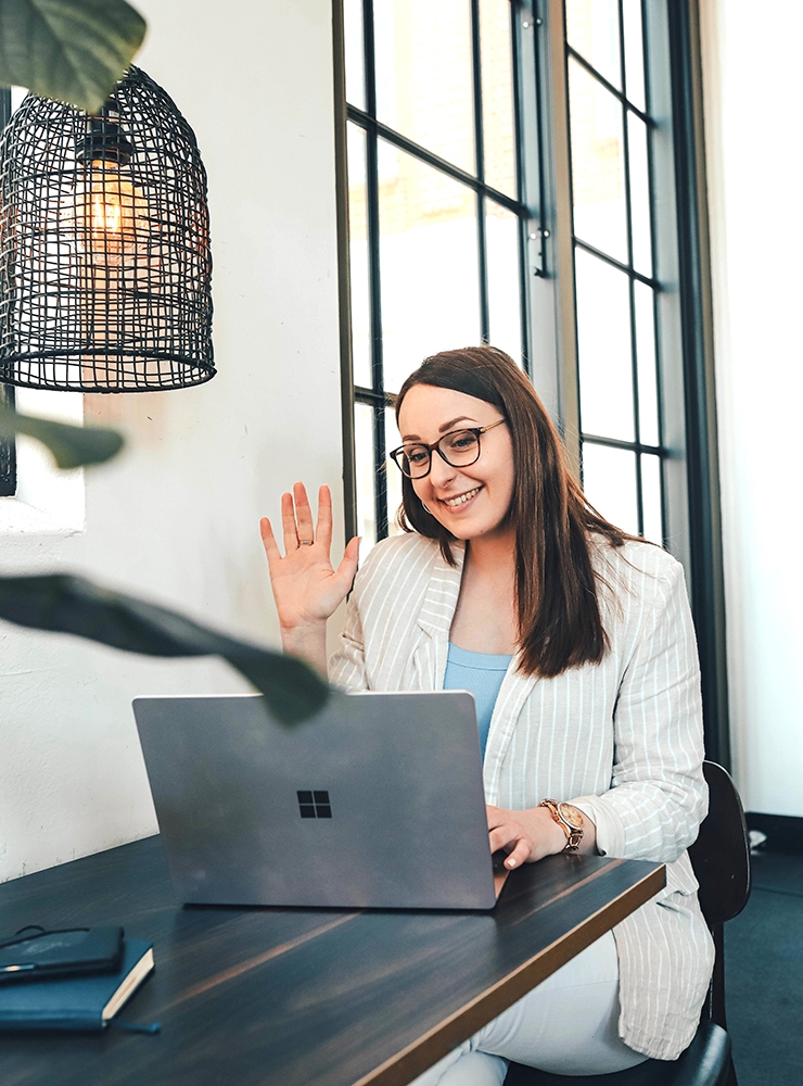 Online French Tutors - Adelaide, Online French tutor in Adelaide greeting students through her laptop, smiling and waving in a stylish, sunlit office space., ,